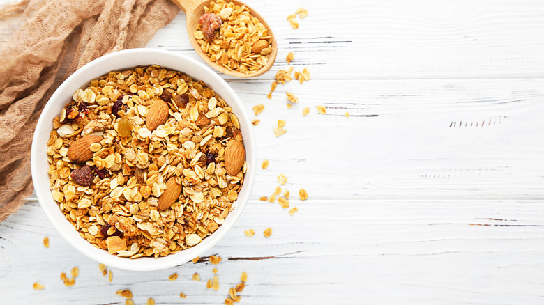 Granola in bowl next to a spoon of granola