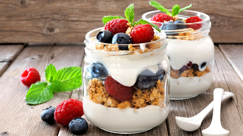 Jars of granola parfait with berries