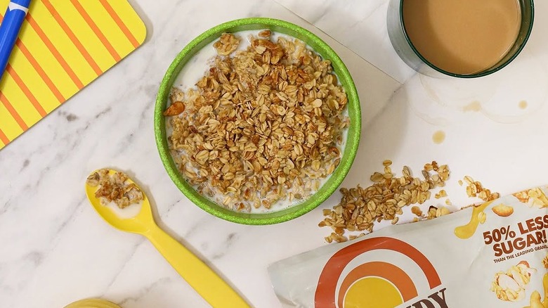 Bowl of Grandy Organics granola next to a spoon