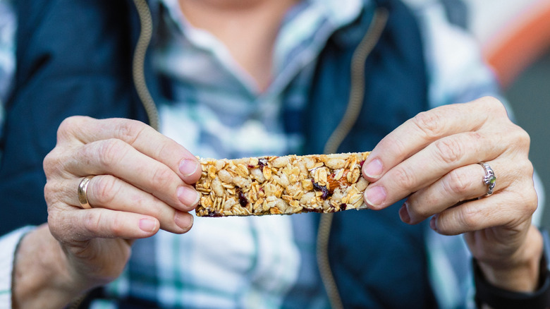 Person holding granola bar