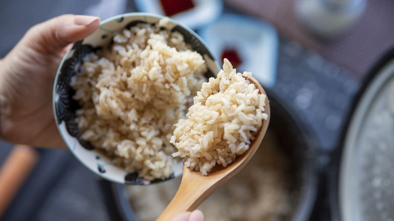 Person spooning rice from bowl