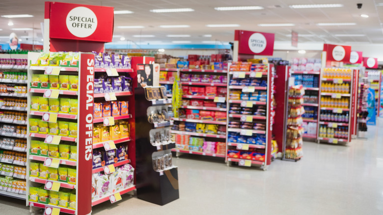 Grocery aisles with big red signs that read