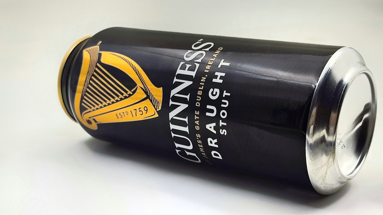 An empty can of Guinness lying on its side.