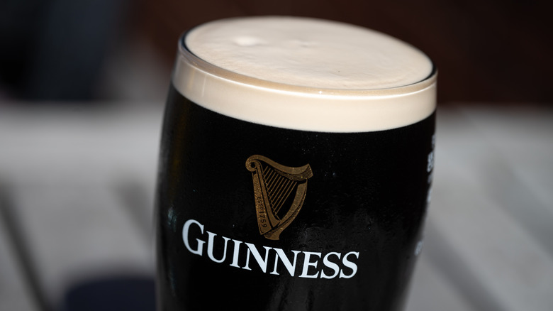 A pint of Guinness Draught on a table.