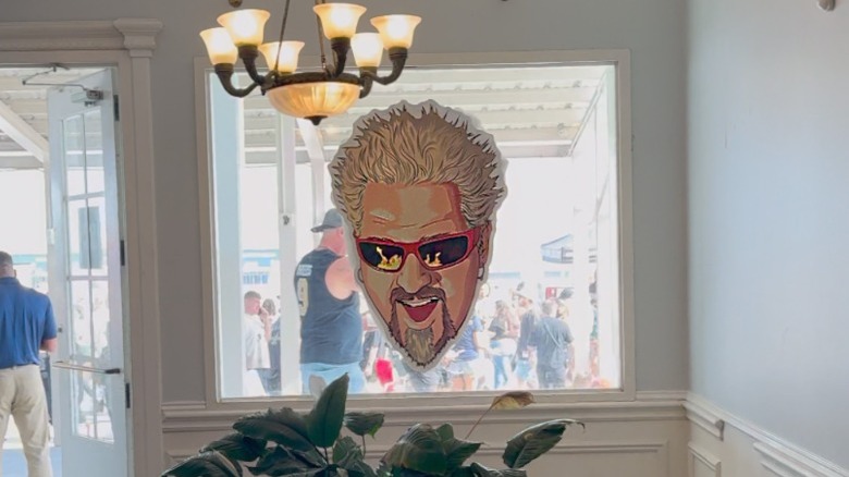 Giant Guy Fieri face on window, Guy's Flavortown Tailgate Super Bowl 2025