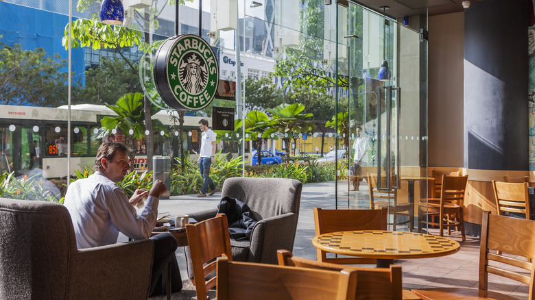 The interior of a glass-fronted Starbucks coffee shop