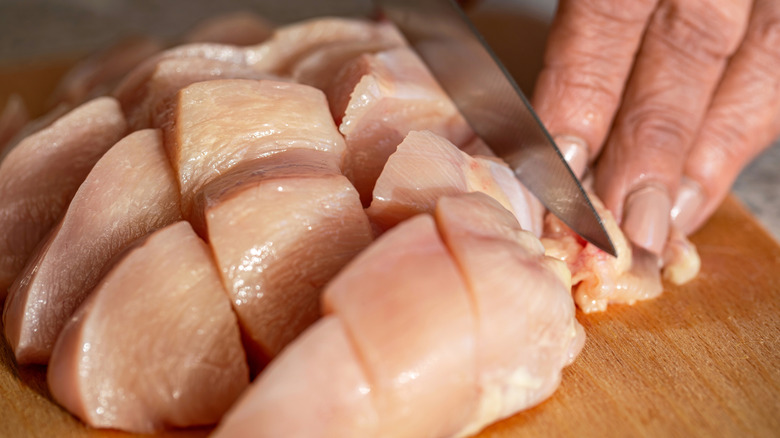 raw chicken on wooden board