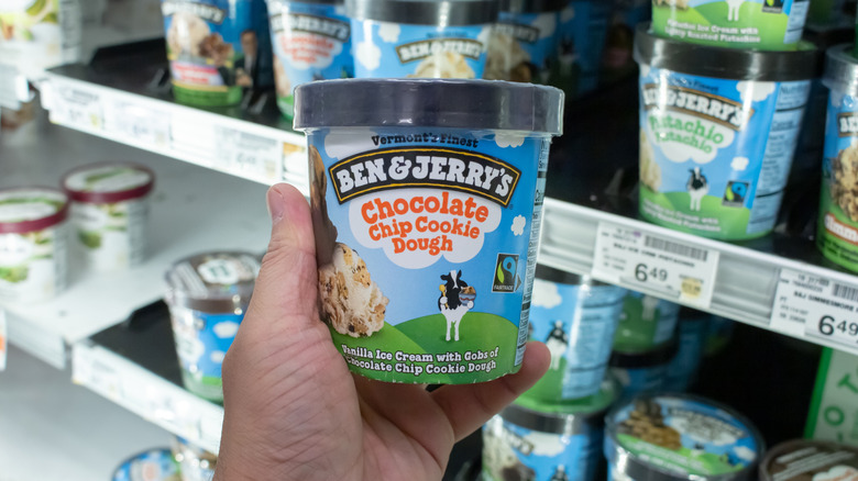 Person grabbing a pint of Chocolate Chip Cookie Dough ice cream out of a cooler