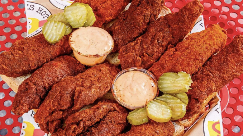 Dave's Hot Chicken with dipping sauce and pickles