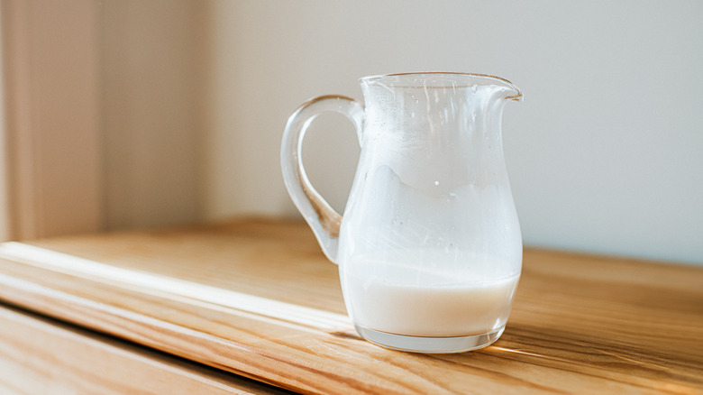 pitcher of milk on a wooden surface