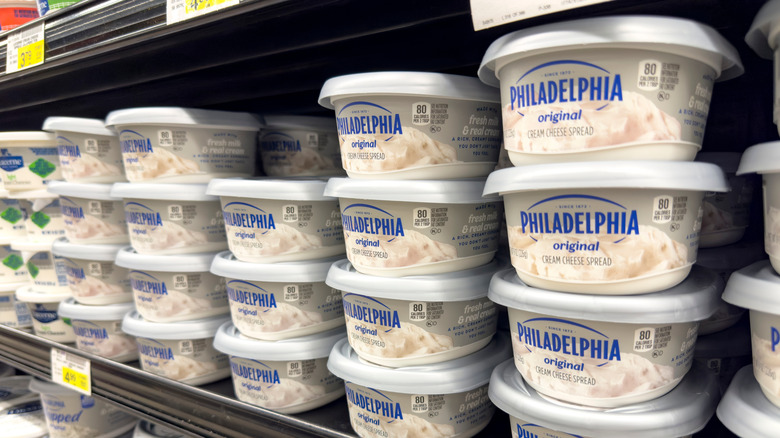 tubs of cream cheese on supermarket shelf