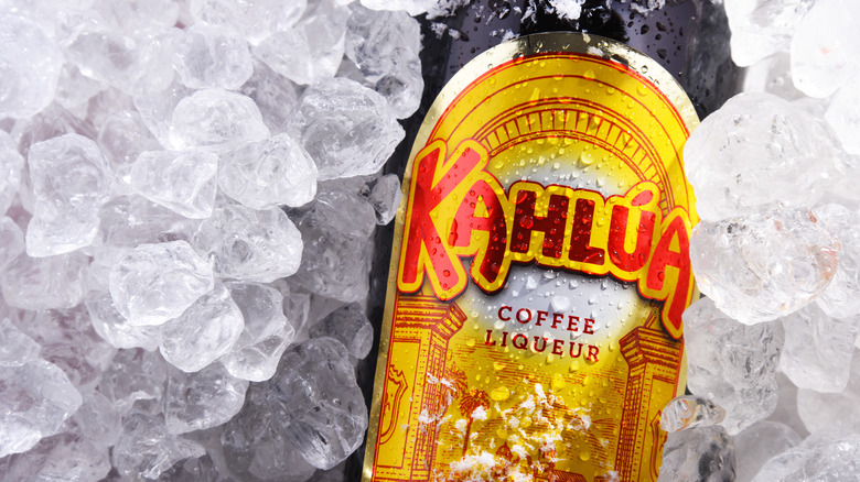 a bottle of kahlua nestled among many ice nuggets