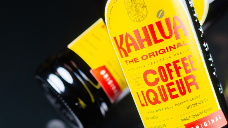 two bottles of kahlua, one in the foreground showing label