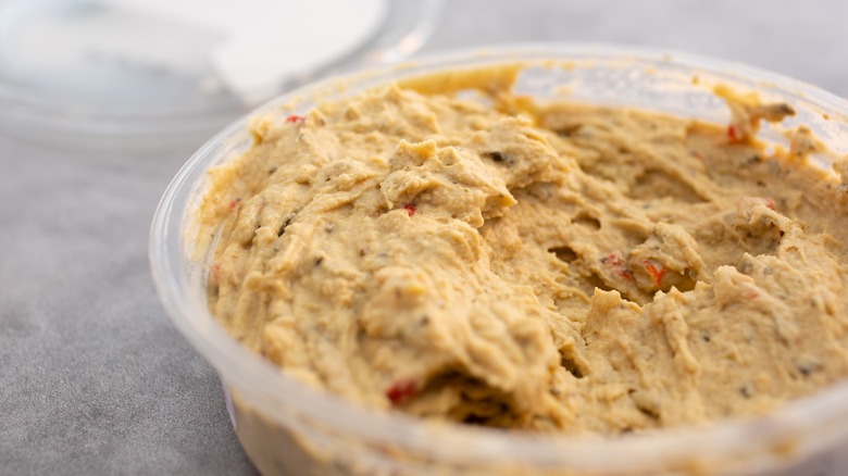 open container of store-bought hummus