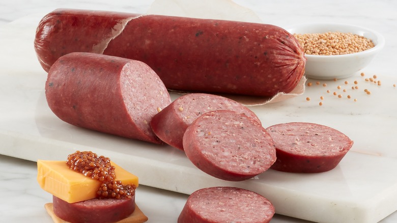 a board of summer sausage and cheese