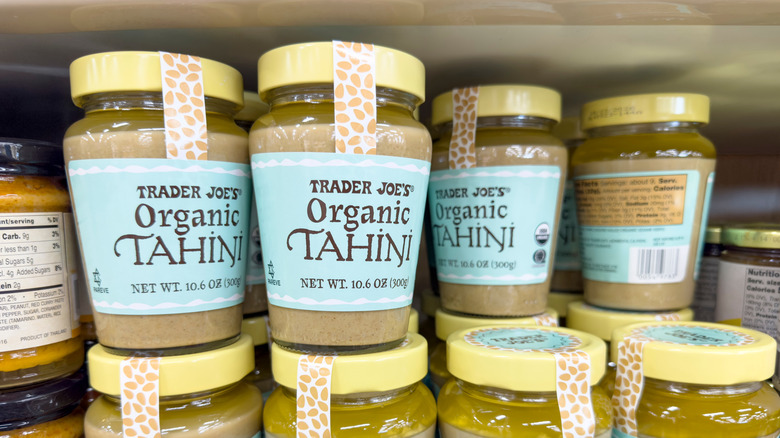 Jars of Trader Joe's organic tahini stacked on a store shelf