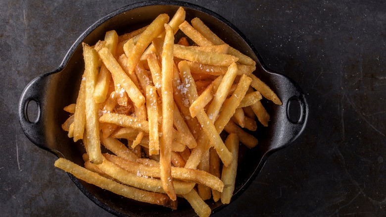 Black pot with crispy french fries inside