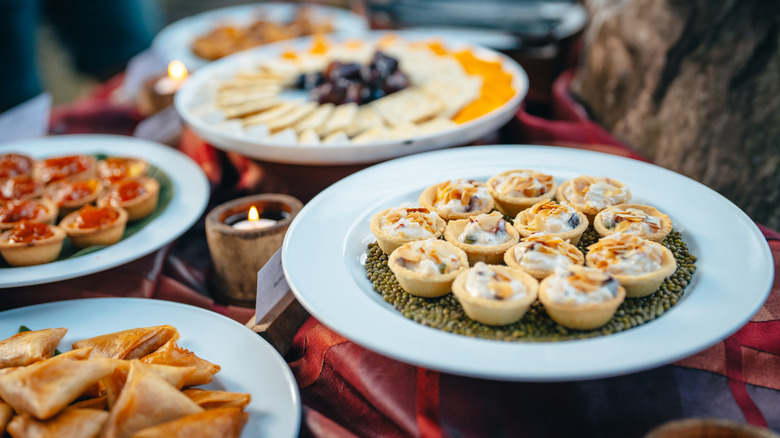 Various plates of bite-sized appetizers