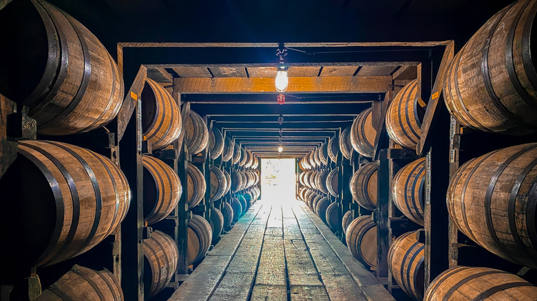 Bourbon barrels stacked in a storage room for aging