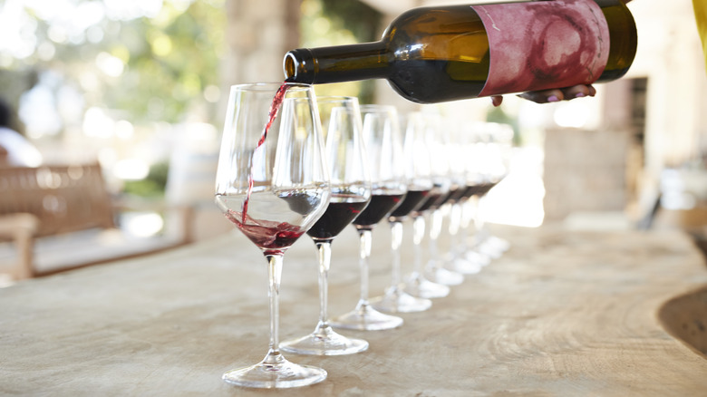 Person pouring flight of wine