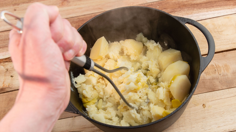 Mashed potatoes being made by hand