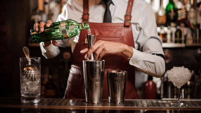 bartender measuring a drink