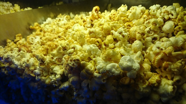 Movie theater popcorn in a plastic dispenser