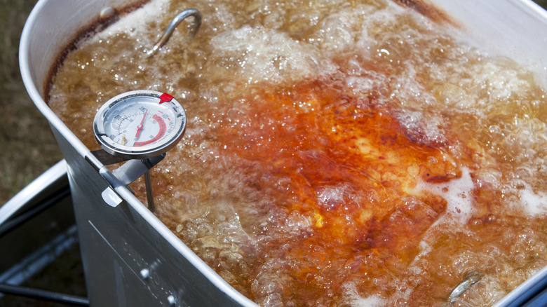 a turkey fryer cooking a turkey in boiling oil