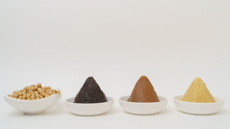 Different types of miso paste in white bowls