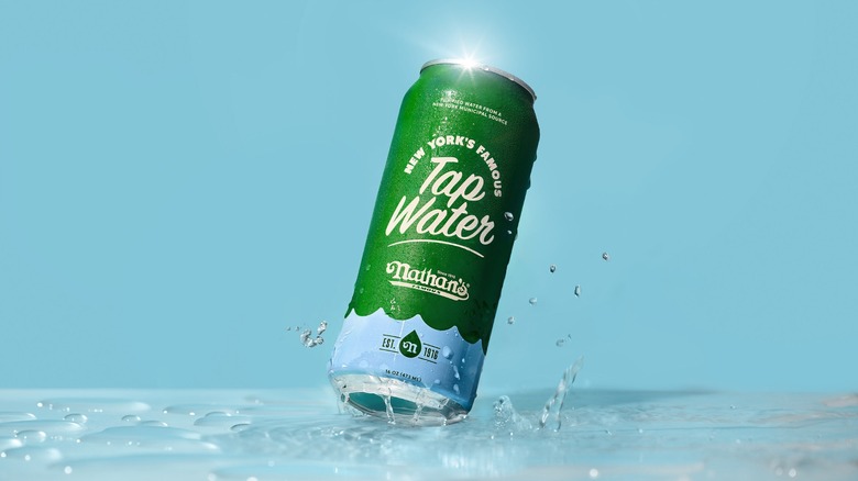 A can of Nathan's Famous New York's Famous Tap Water on a wet surface