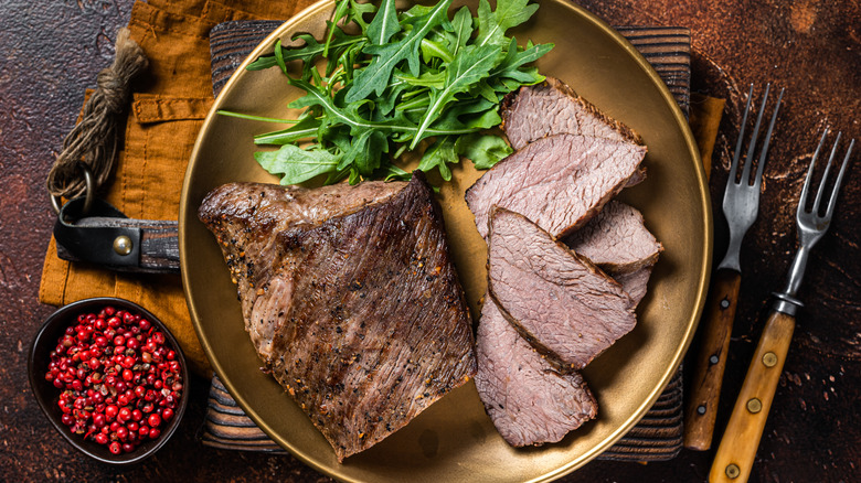 A knife slicing through a steak.