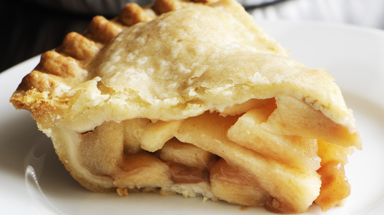 An apple pie slice on a white plate