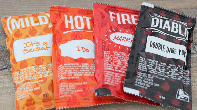 Four packets of Taco Bell hot sauces.