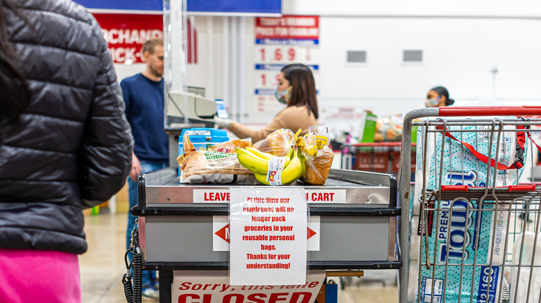 costco checkout line with groceries on belt