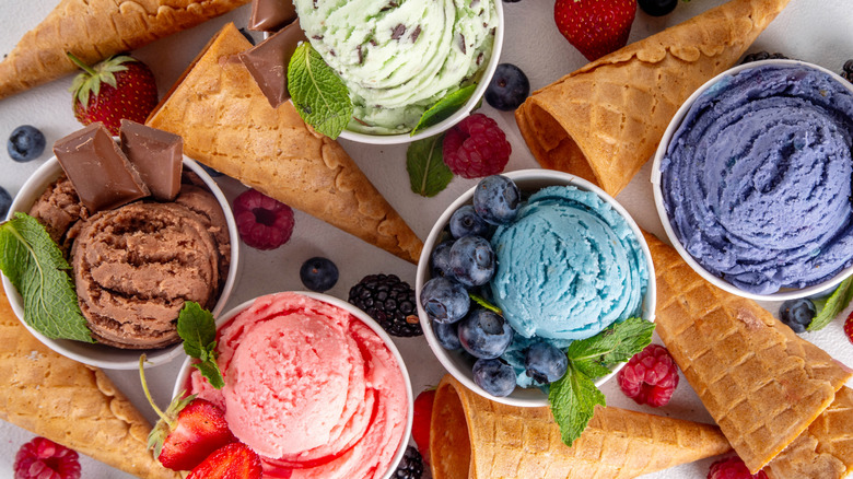 An array of colorful, bright ice cream and waffle cones.