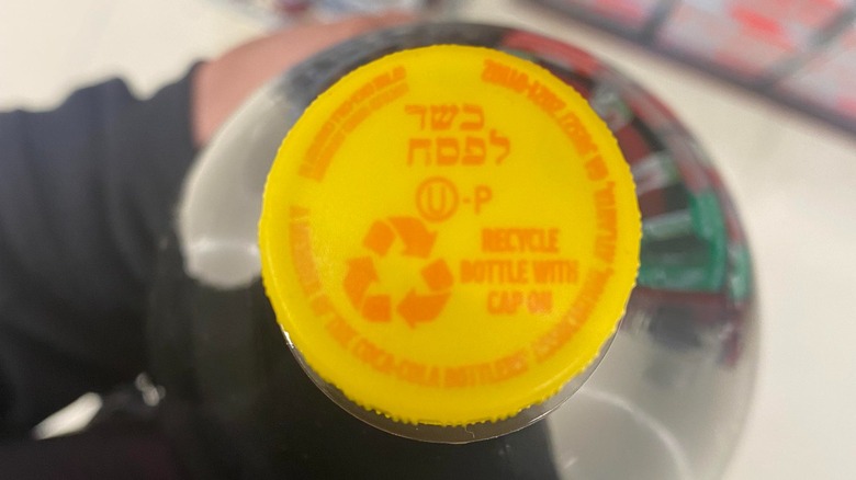 A top-down view of the yellow cap that indicates a bottle of Coca-Cola is Kosher for Passover