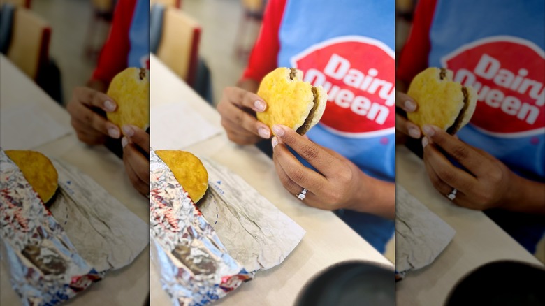 Woman eating a Dairy Queen breakfast biscuit sandwich