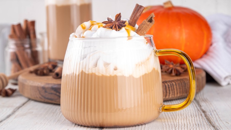 homemade pumpkin spice latte with whipped cream, star anise, and cinnamon sticks