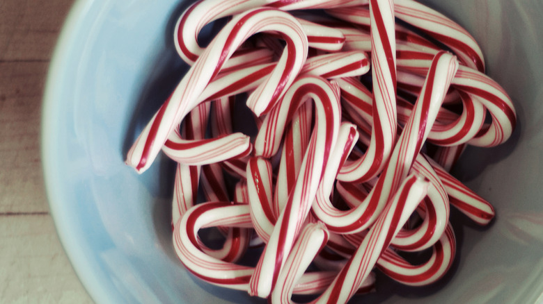 candy canes in a blue bowl