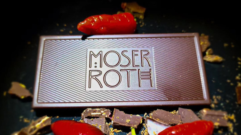 unwrapped Moser Roth chocolate bar among peppers