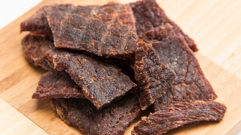 Close-up of beef jerky on a wooden plate