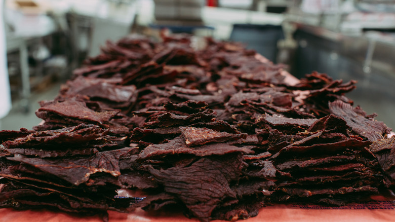 Stacks of beef jerky in a commercial kitchen