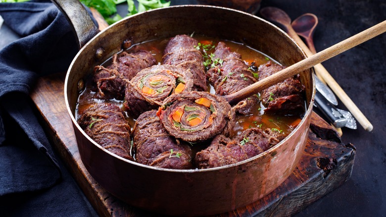 Slow cooked beef olives with vegetables and bacon served in gravy