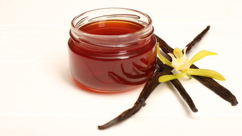 vanilla extract in a jar with real vanilla beans next to it