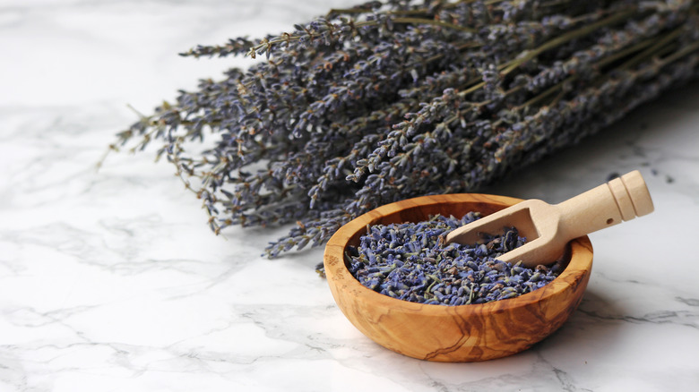 dried lavender in bowl with lavender in background