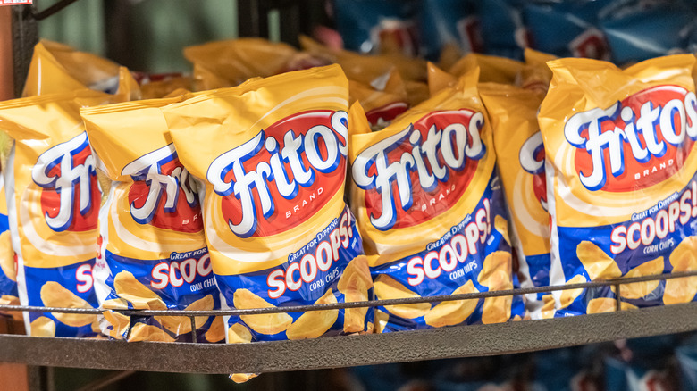 Several bags of Fritos Scoops chips