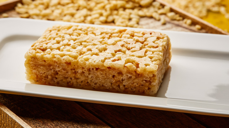 Rice Krispies treat on a rectangular wooden plate