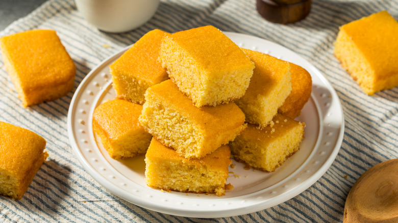 Squares of cornbread on a white plate