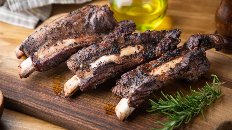 Beef back ribs on a wooden cutting board