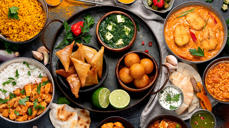 An assortment of Indian foods and dishes on a table